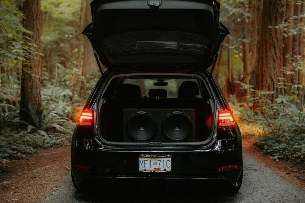 Black Car with Speakers on Car Trunk